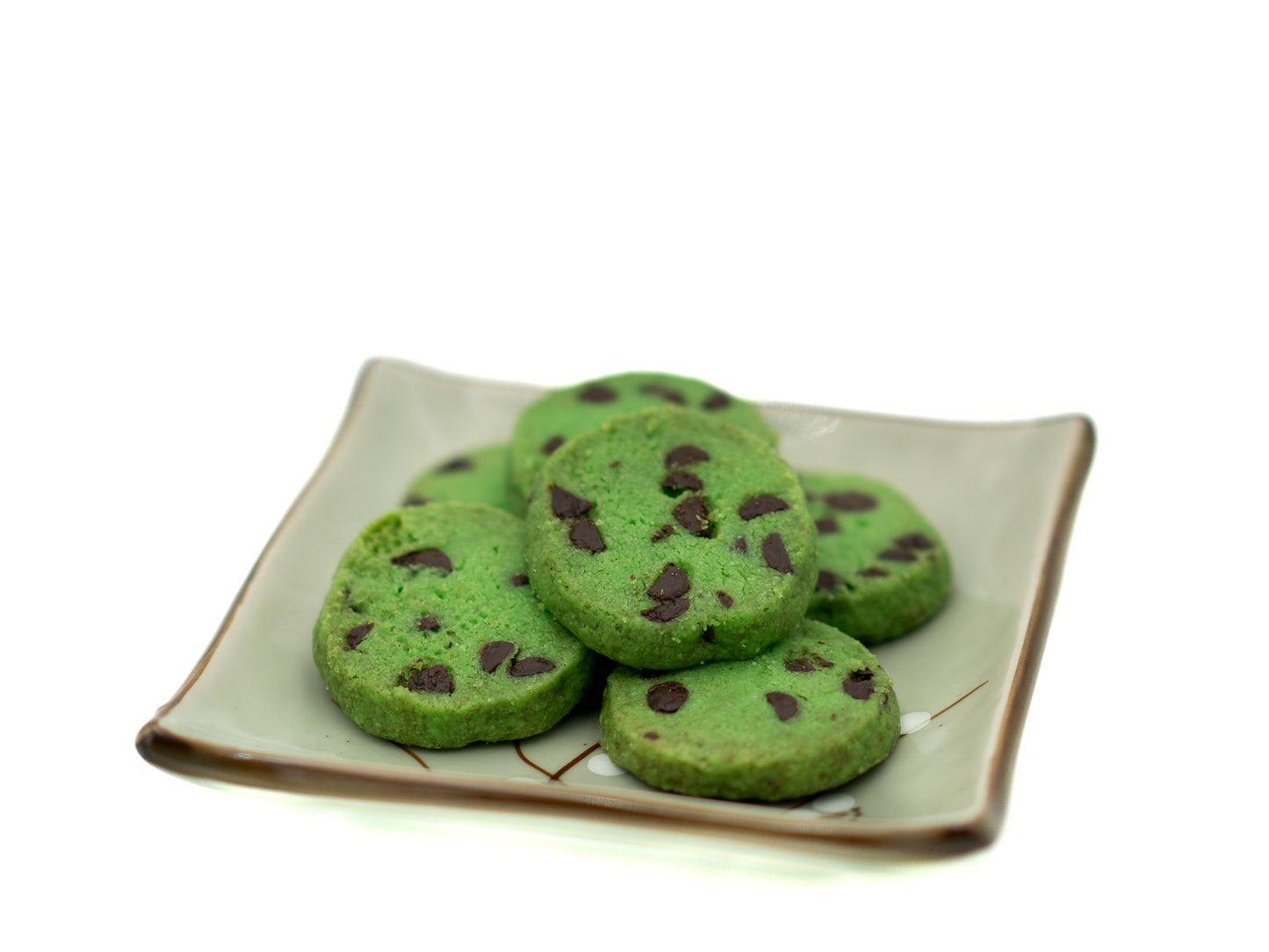 pandan chocolate chip cookies with chocolate chips on a square plate against a white background