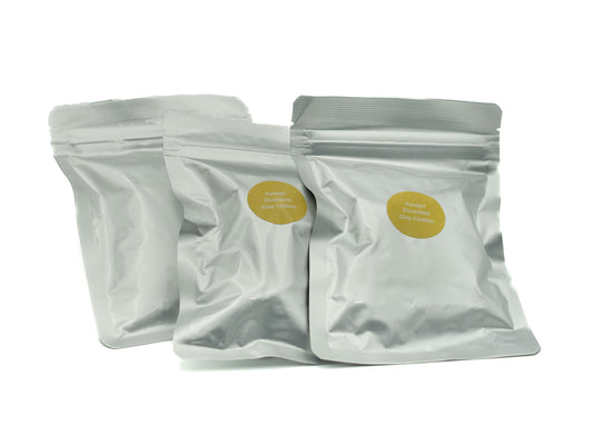 Three white snack bags with yellow labels on a white background, pandan choc chip cookies