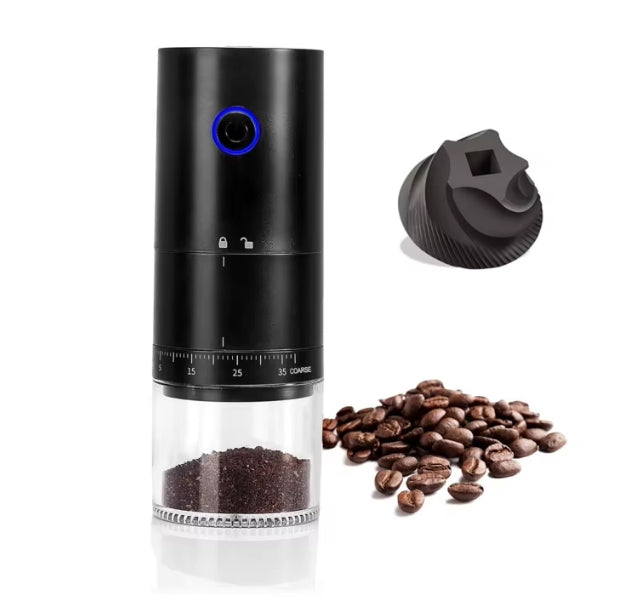 Black coffee grinder with clear container, coffee beans, and black cap on white background